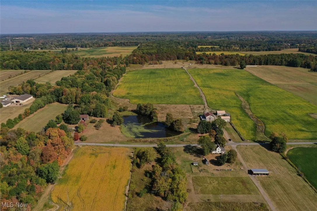 Aerial view of property and surrounding area with rural landscape and agricultural land