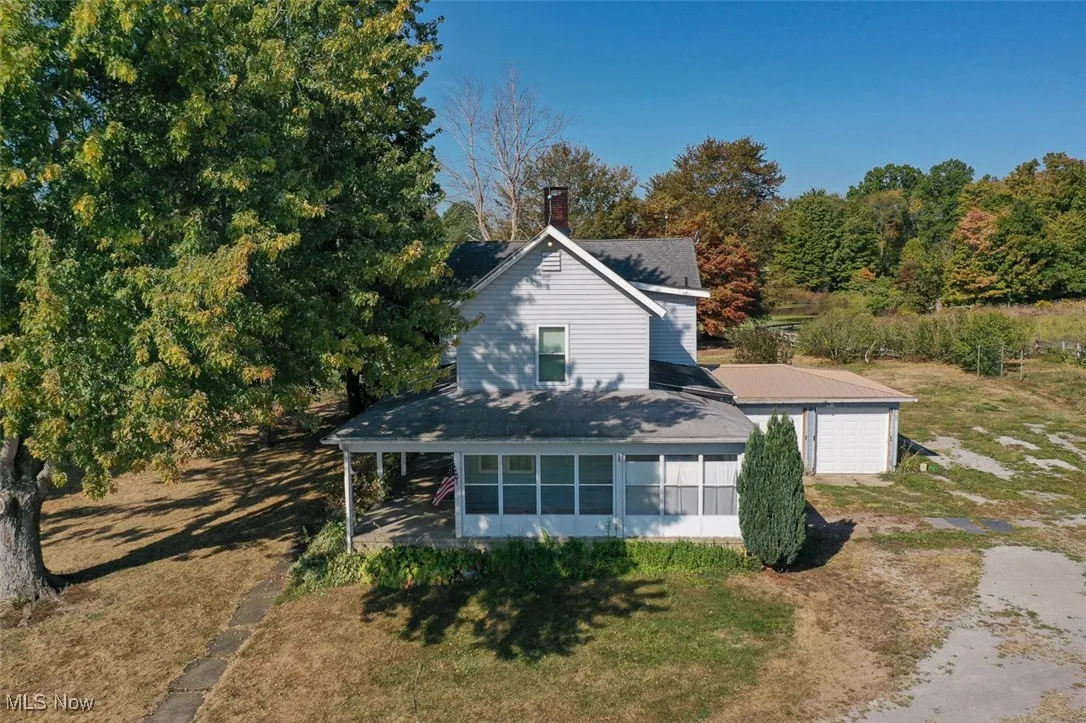 View of side of property featuring a garage and a chimney