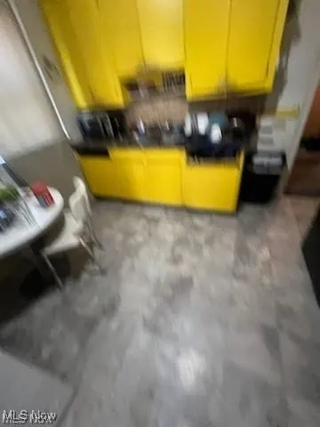 Kitchen featuring dark countertops and finished concrete flooring