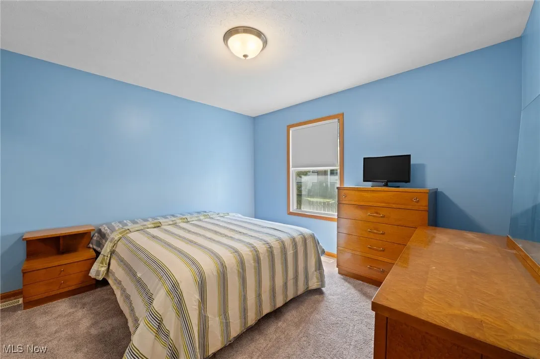 Bedroom with carpet and baseboards