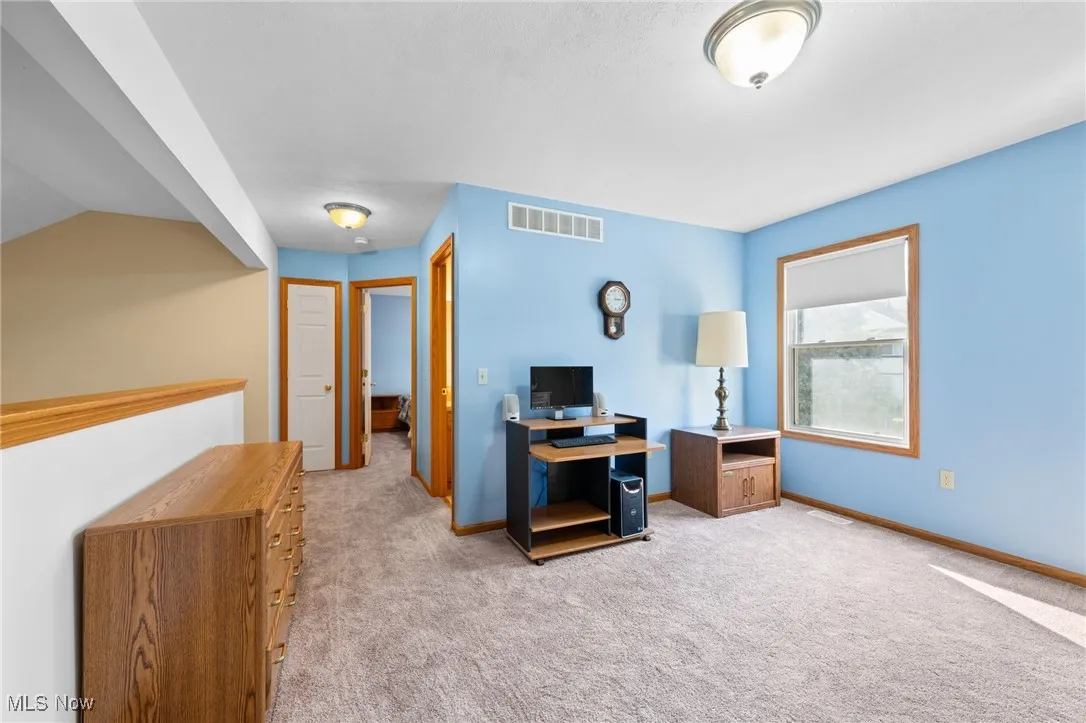 Office space featuring light carpet and baseboards