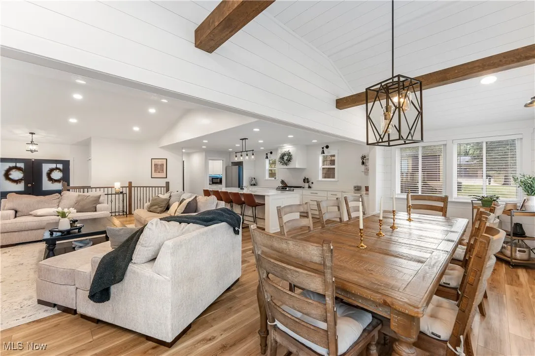 Dining area with recessed lighting, light wood-style flooring, and a chandelier