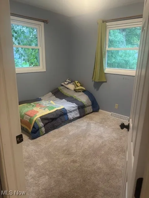Carpeted bedroom featuring baseboards
