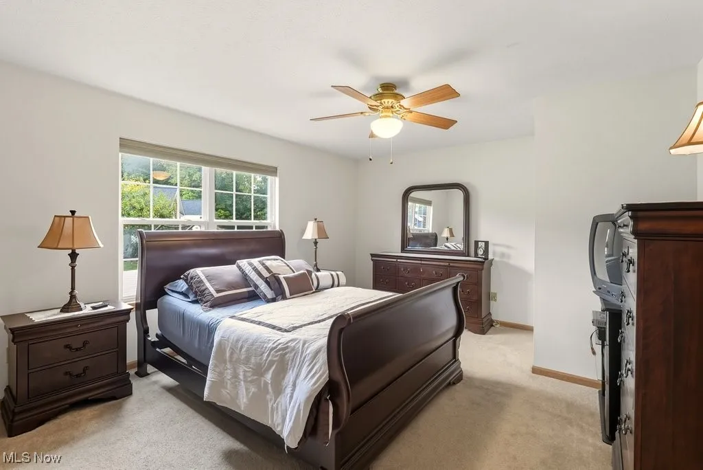 Bedroom with light carpet and ceiling fan