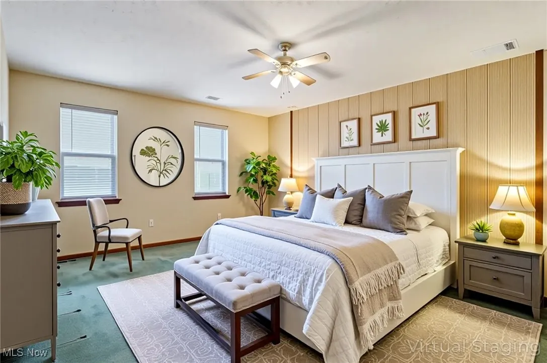 Bedroom with light colored carpet and ceiling fan