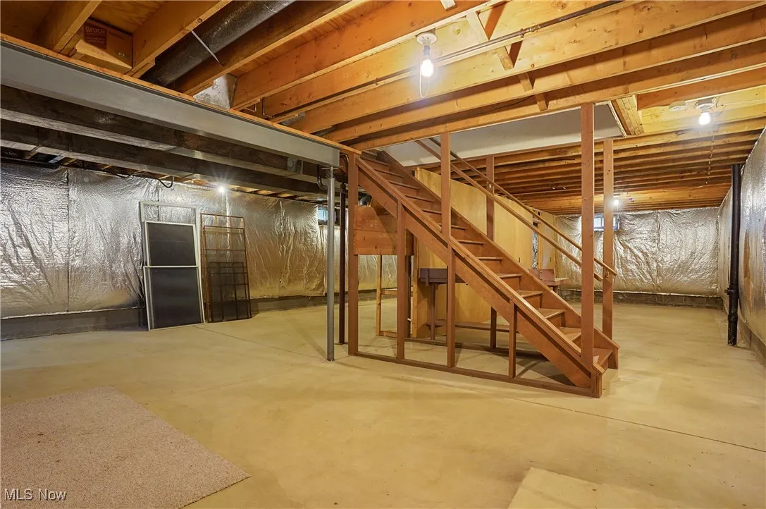 Unfinished basement featuring stairs