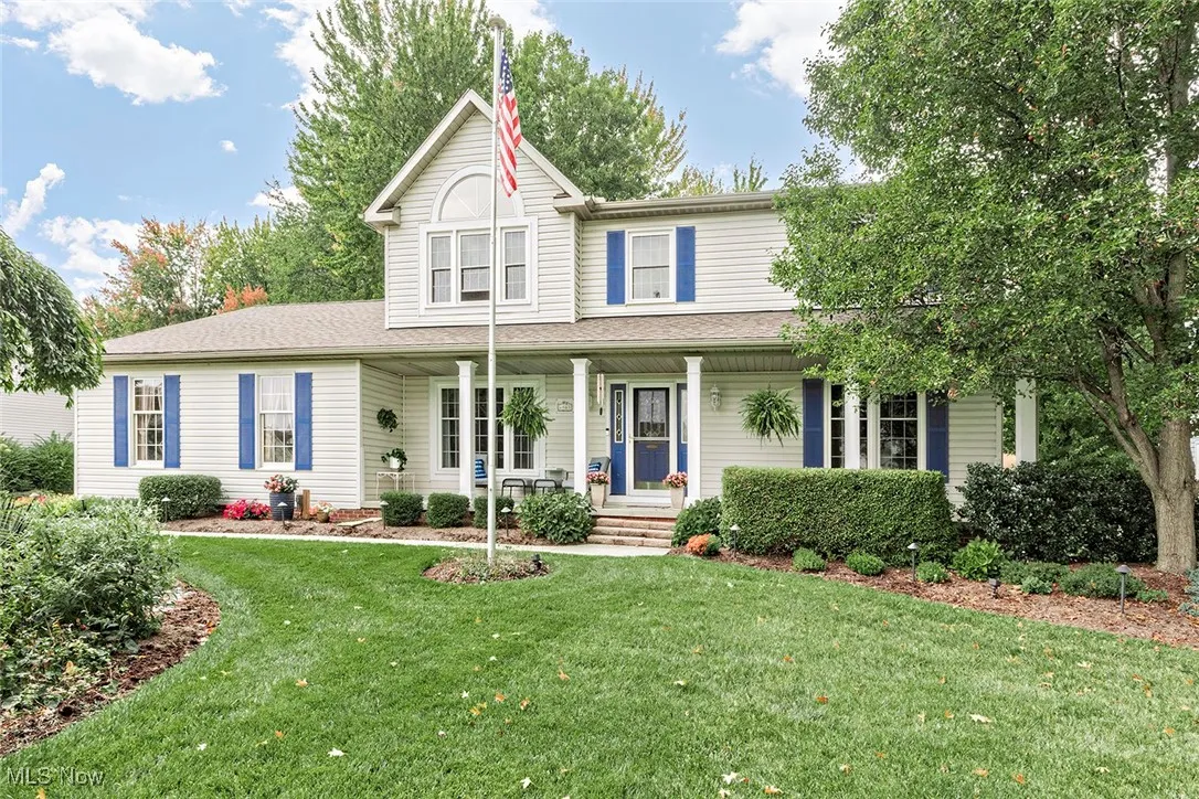 View of front of home with covered porch and a front lawn