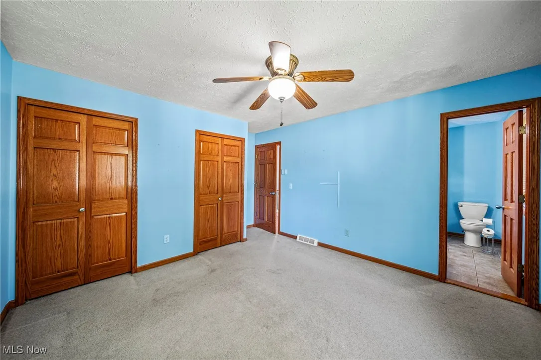 Primary bedroom with double closet and access to full bath