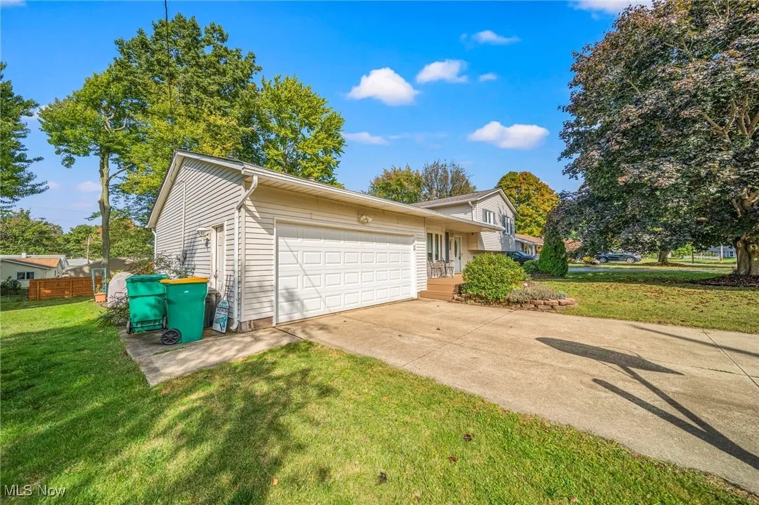 Two car attached garage with man door and opener.