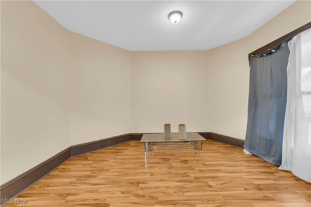 Empty room with light wood-type flooring and baseboards