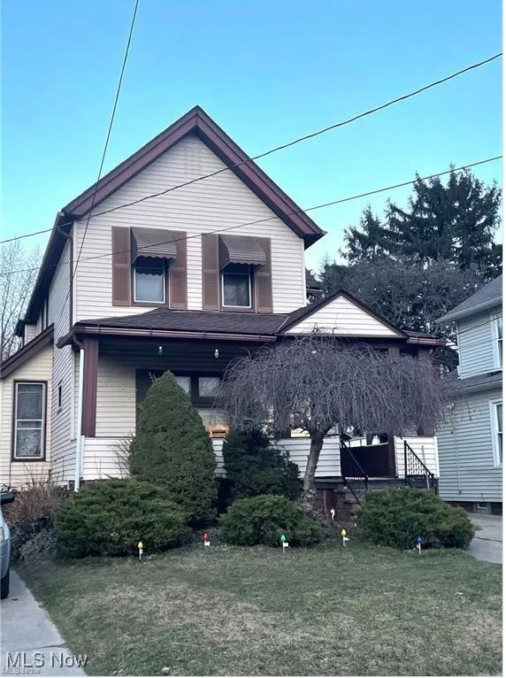 View of front of home with a front yard and covered porch. Downstairs tenant access