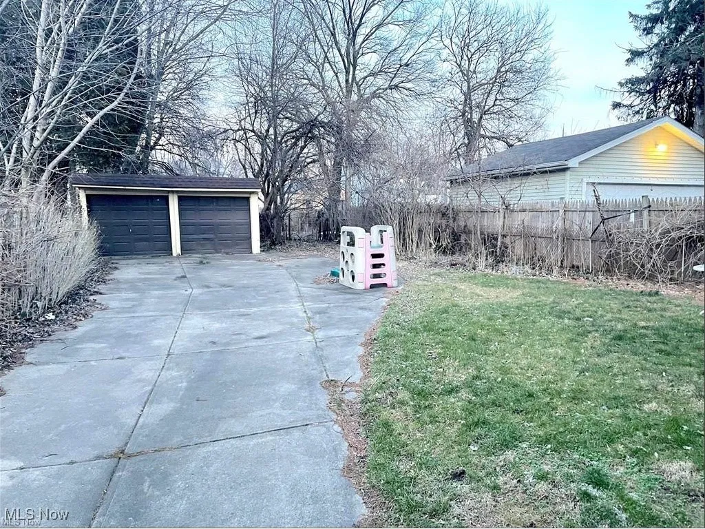 View of the back yard with 2 car garage