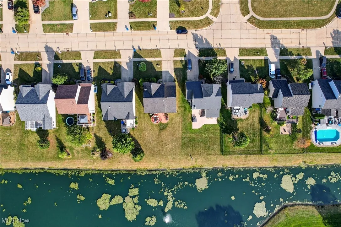 Aerial overview of property's location with a large body of water and nearby suburban area