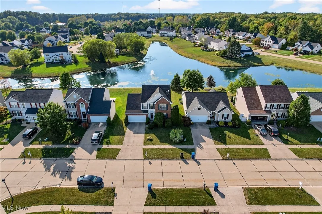 Aerial perspective of suburban area with a nearby body of water
