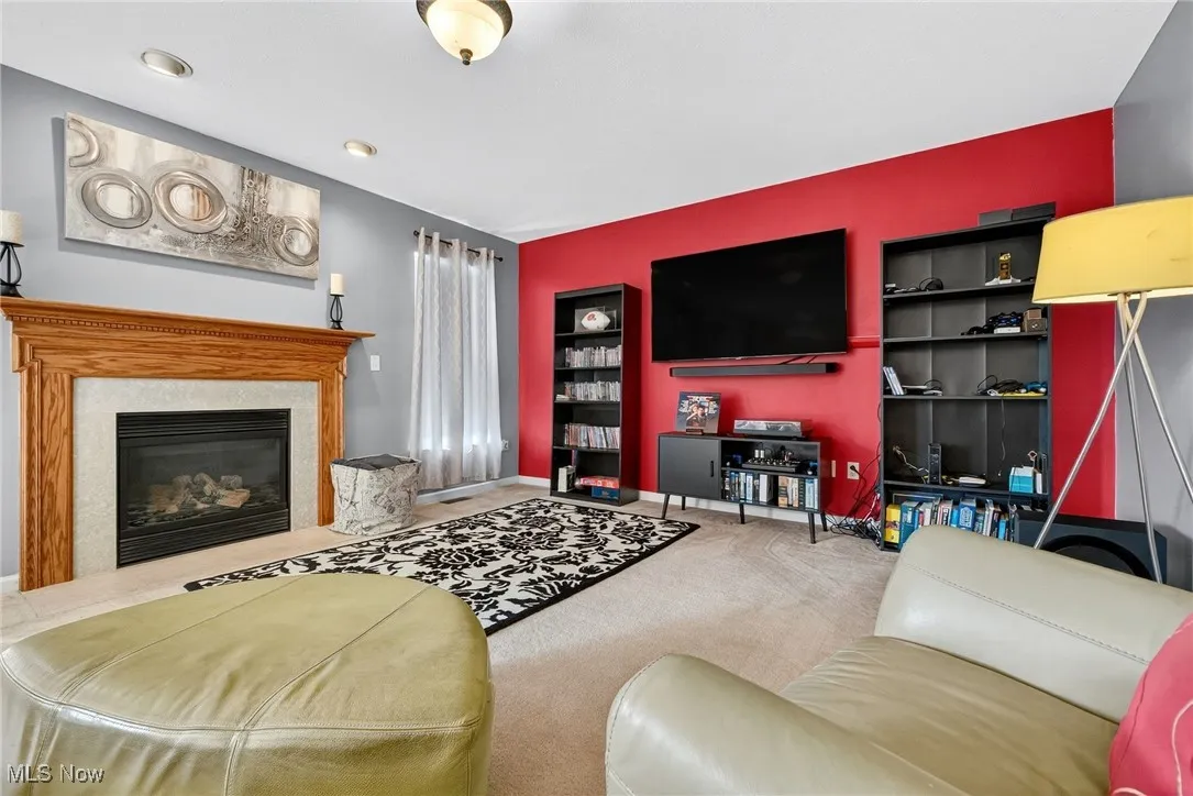 Living room with a premium fireplace and carpet flooring
