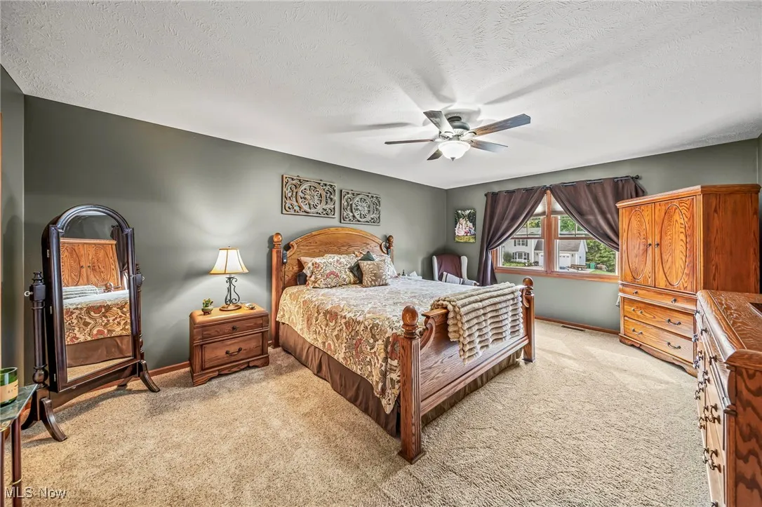 Primary bedroom with ceiling fan