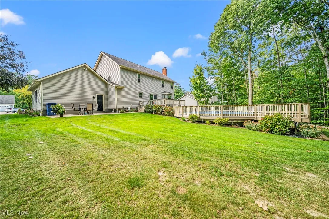 View of grassy yard with a patio area