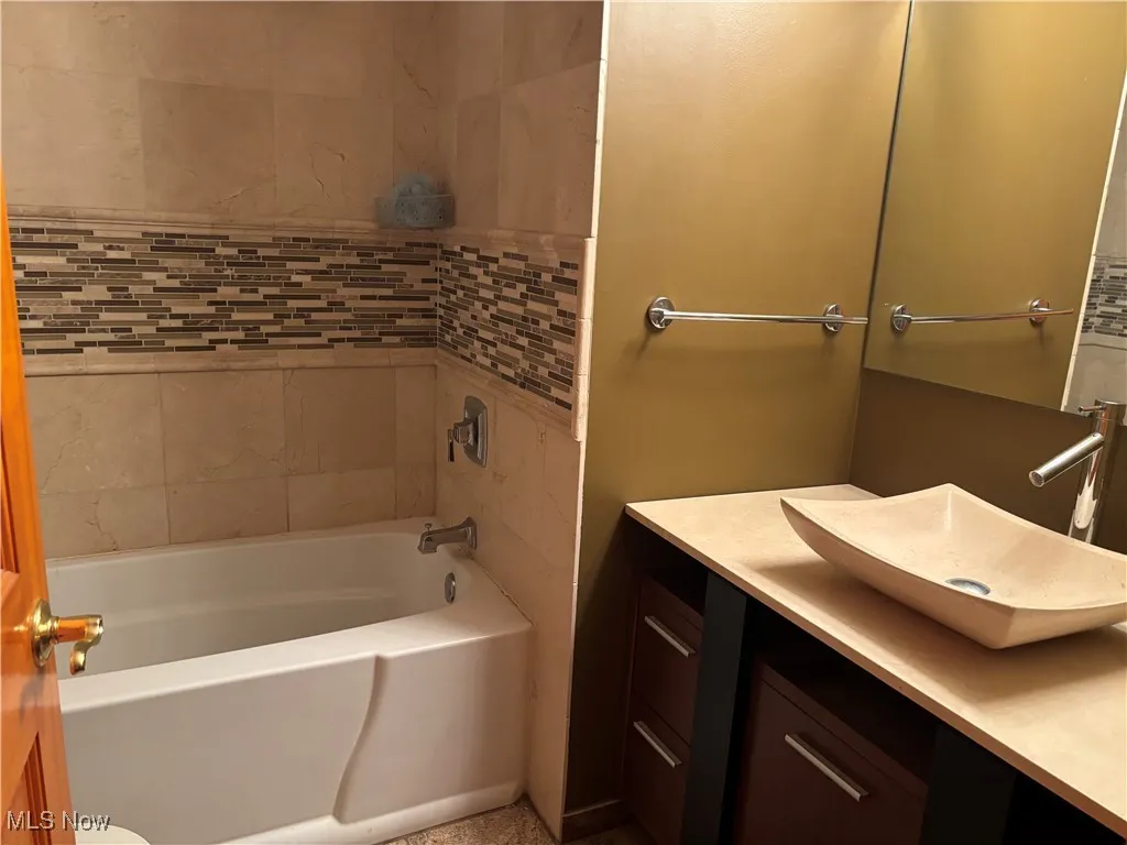 Bathroom featuring a bath and vanity