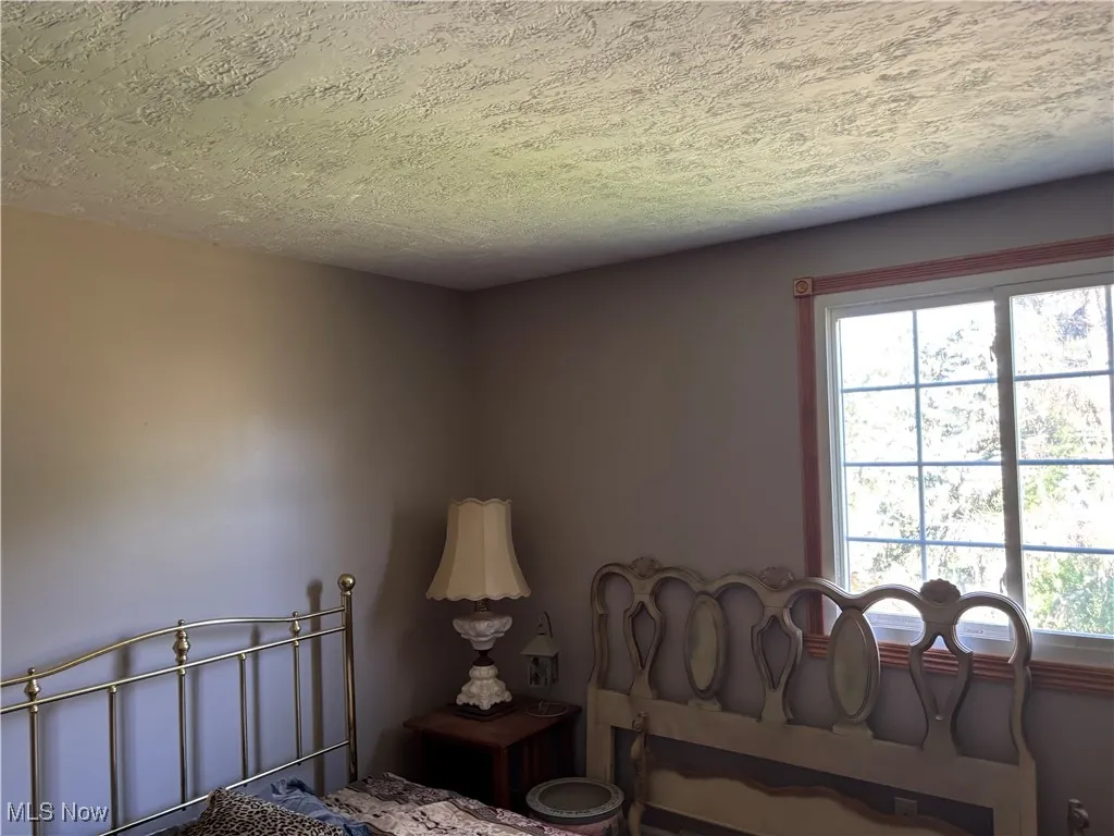Bedroom featuring a textured ceiling