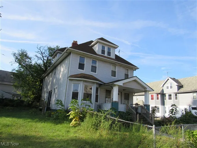 Traditional style home featuring a chimney and a porch