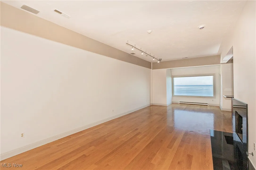 Hardwood floors and a gas fireplace are special features in the Living Room