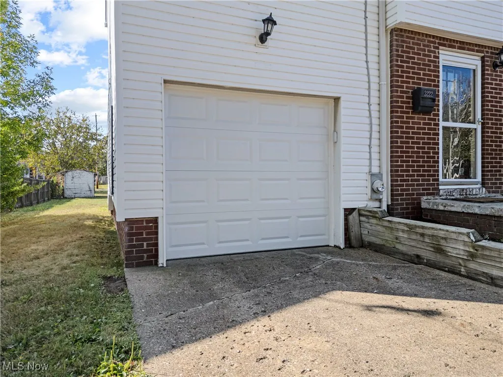 Garage featuring concrete driveway
