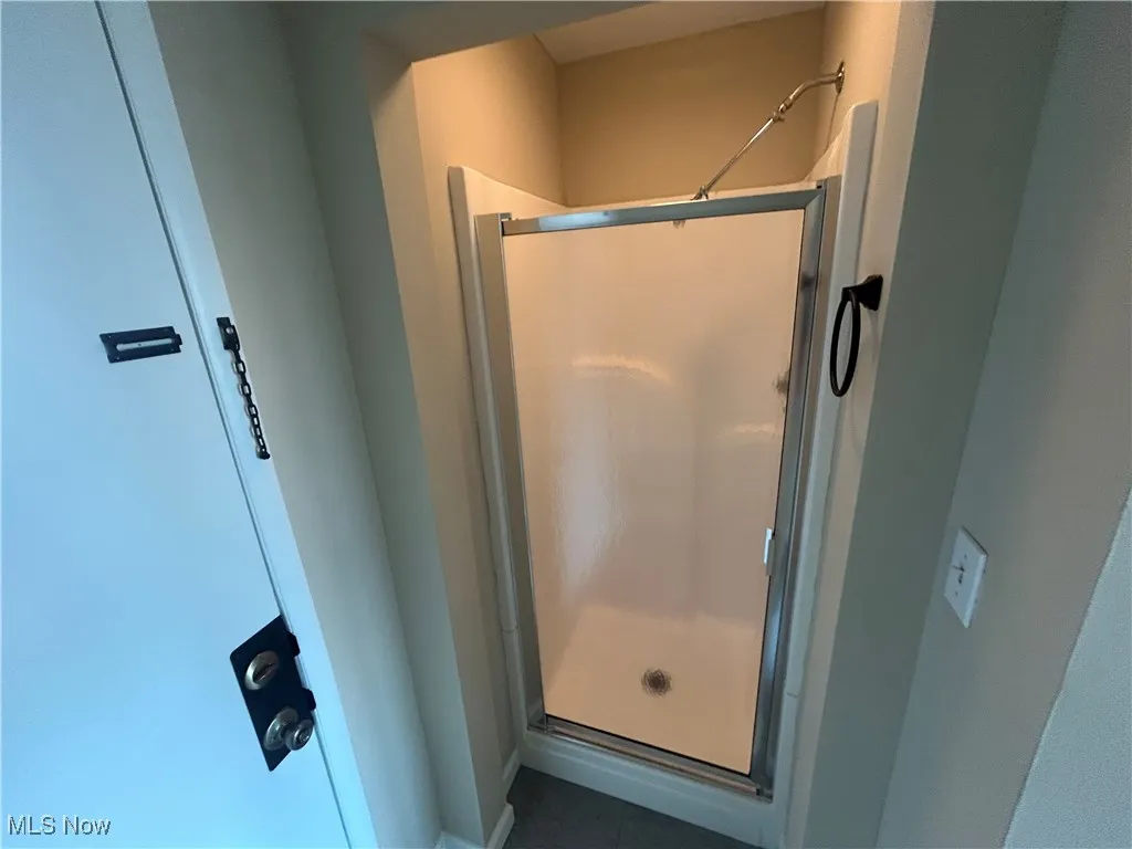 Bathroom Featuring fiberglass shower stall.