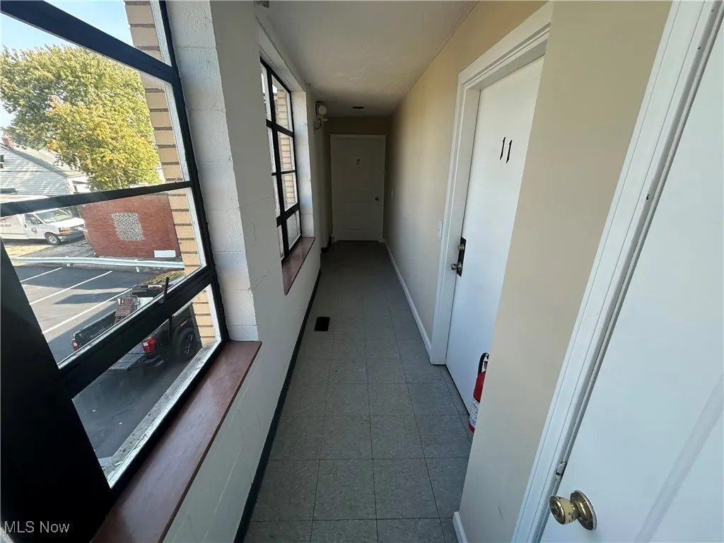 Corridor featuring baseboards
