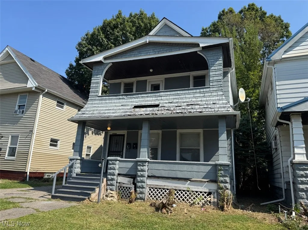 View of front of house featuring a porch and a balcony