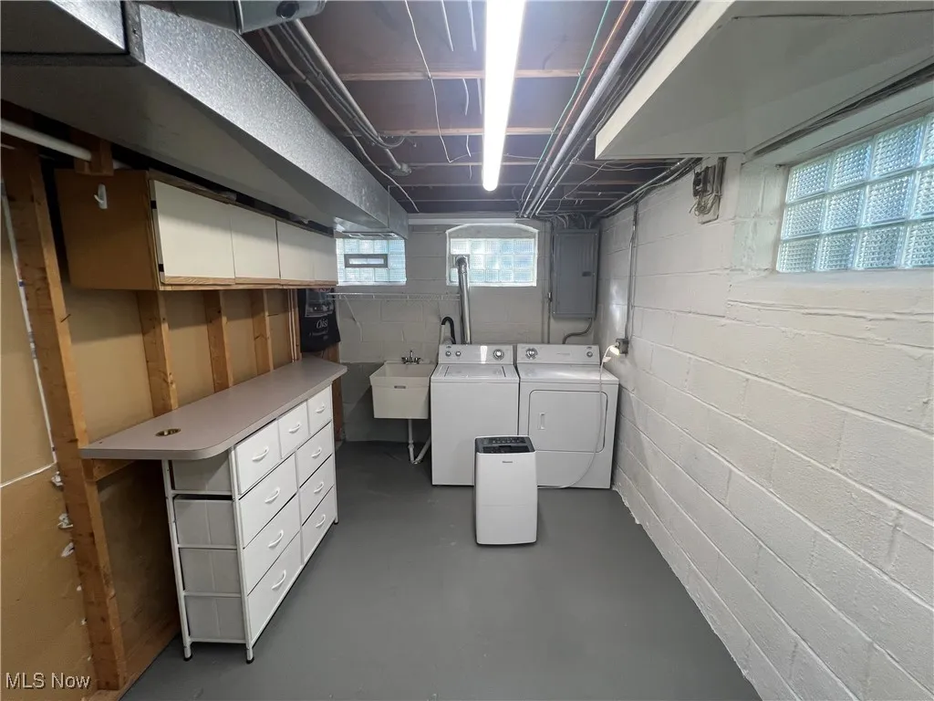 Basement with electric panel and independent washer and dryer