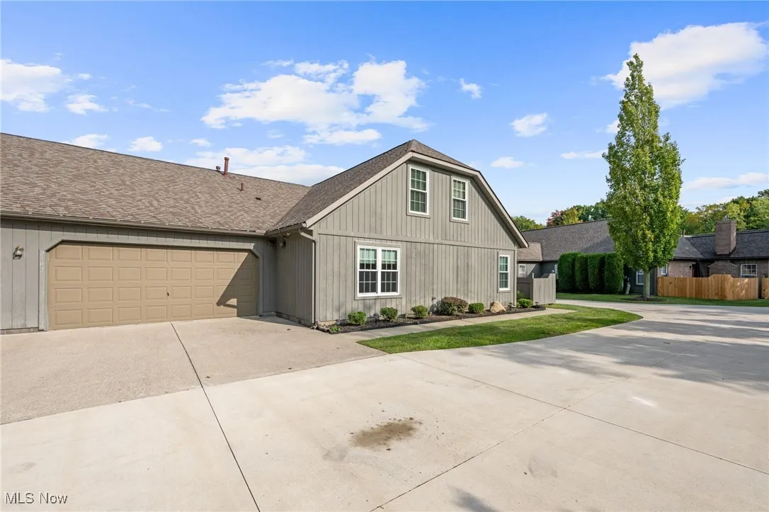 View of front facade featuring driveway, and an attached garage