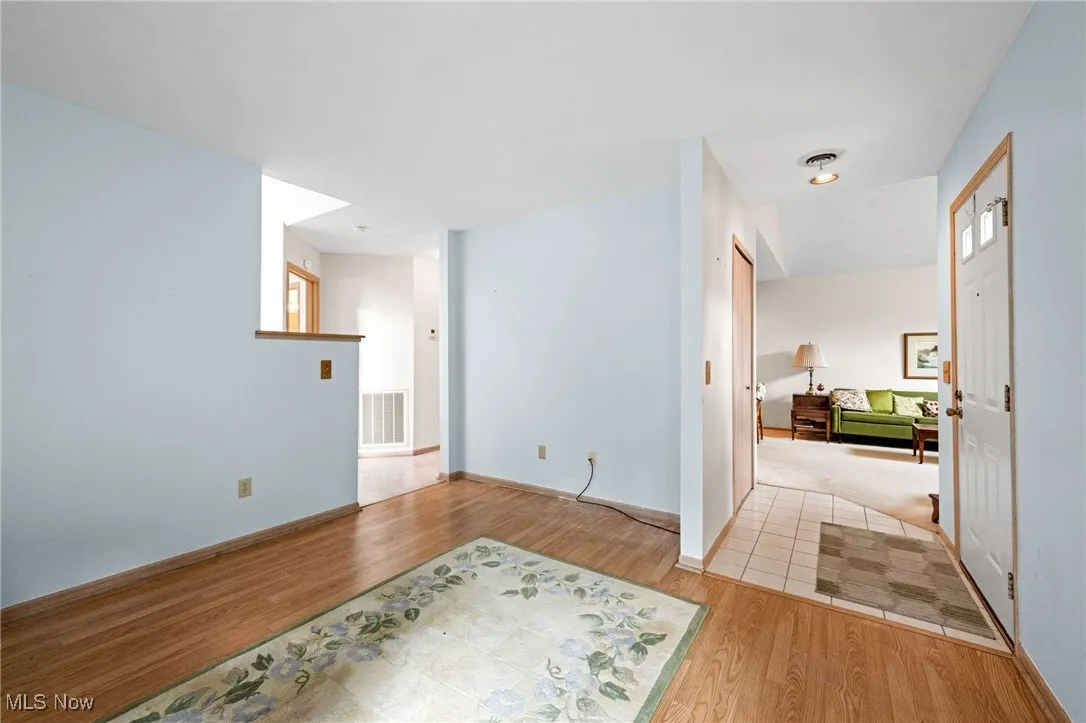 Unfurnished room featuring light wood-type flooring and baseboards