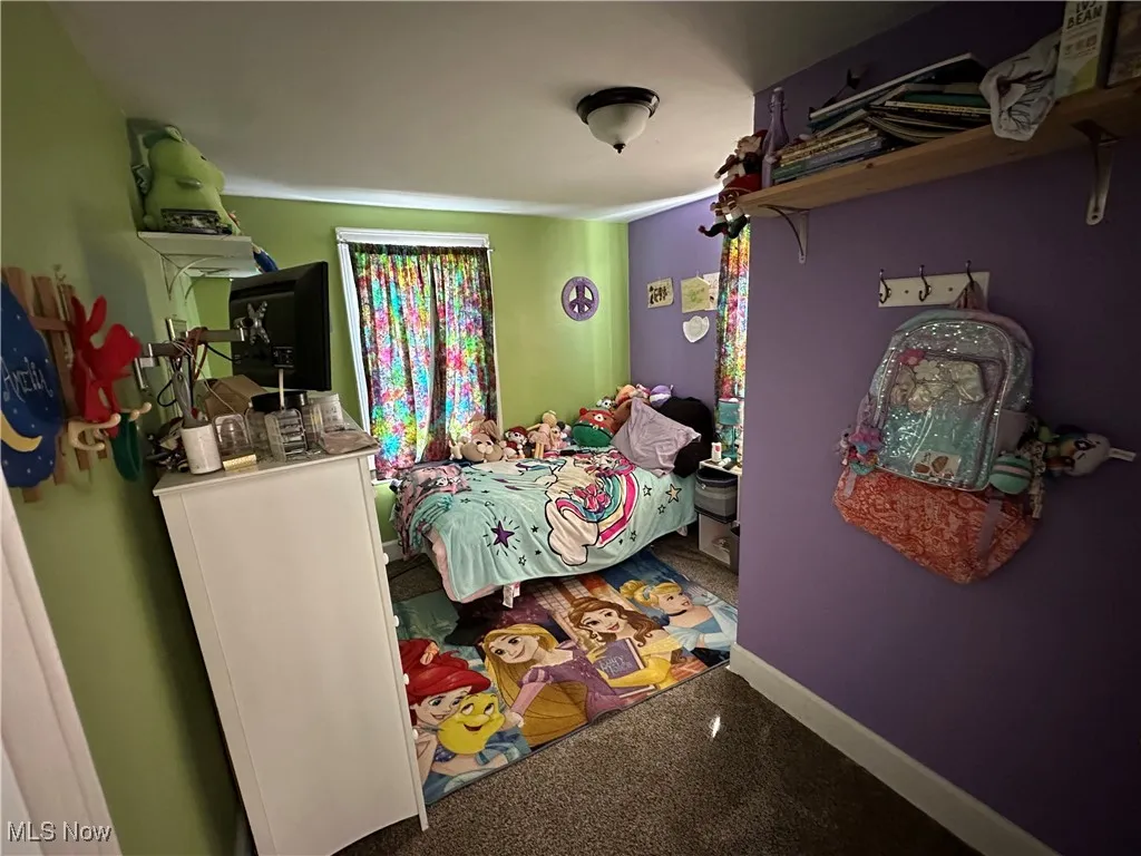 Bedroom featuring carpet flooring and baseboards