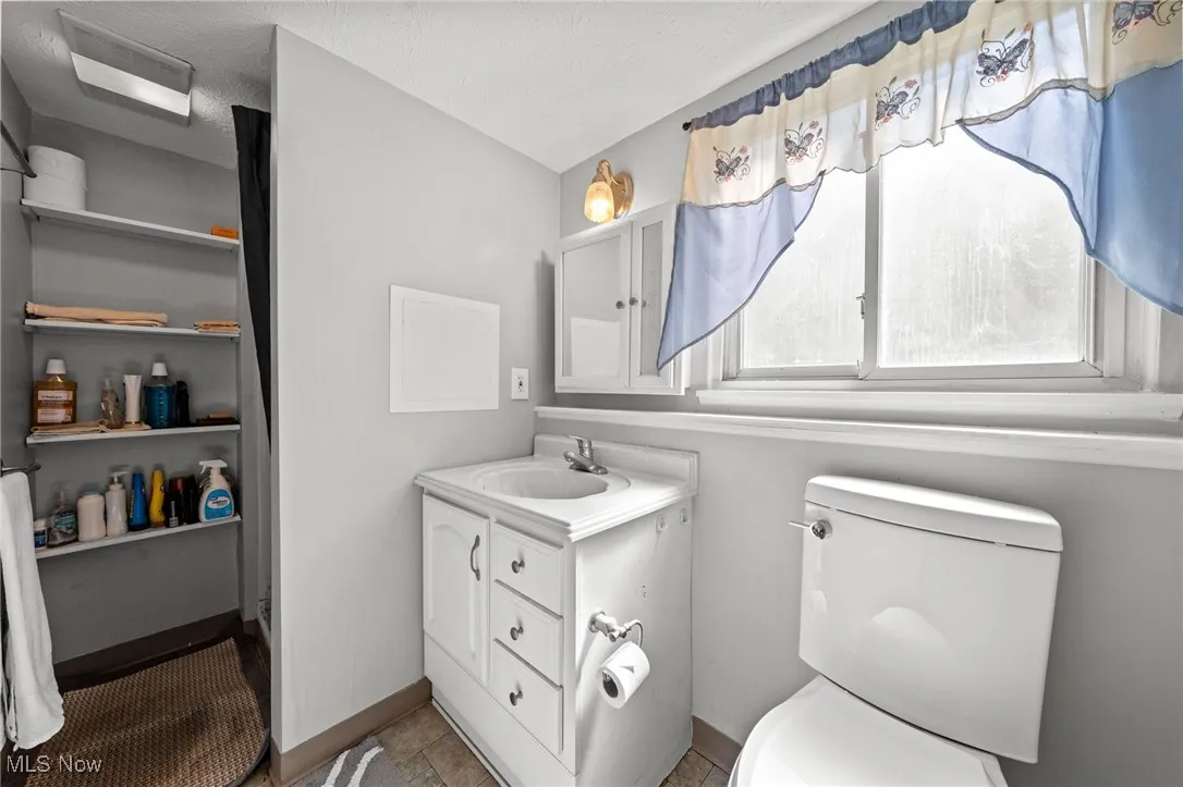 Bathroom with vanity and light tile patterned flooring