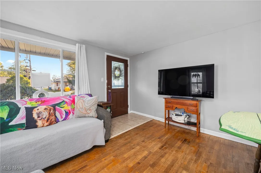 Living area with light wood-style flooring and healthy amount of natural light