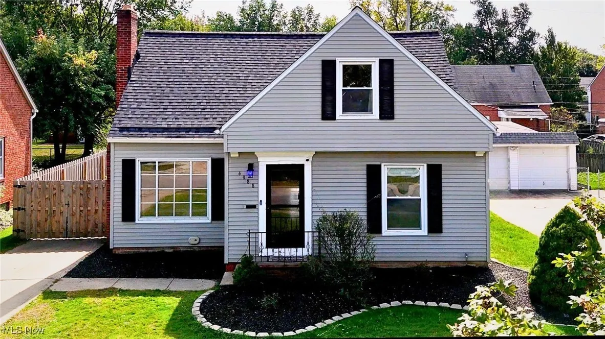 View of front of home featuring a shingled roof and a chimney