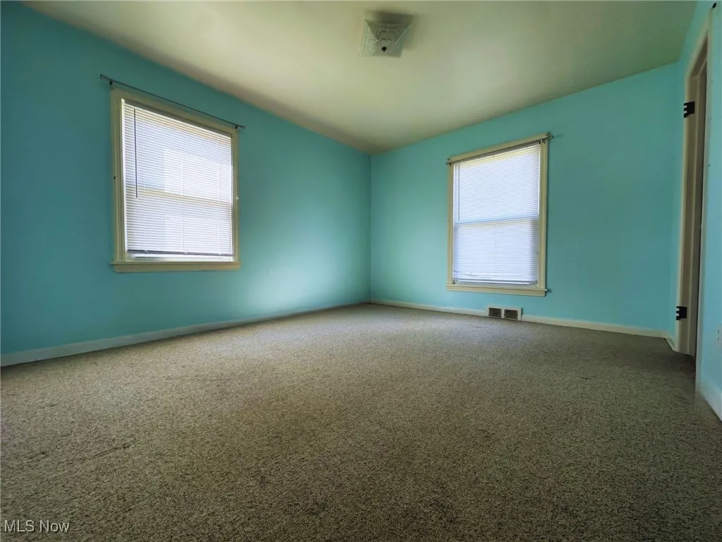 Spare room with carpet flooring and baseboards