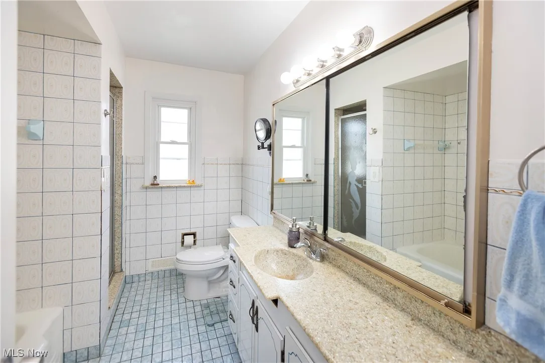 Large bathroom with tub and stand up shower