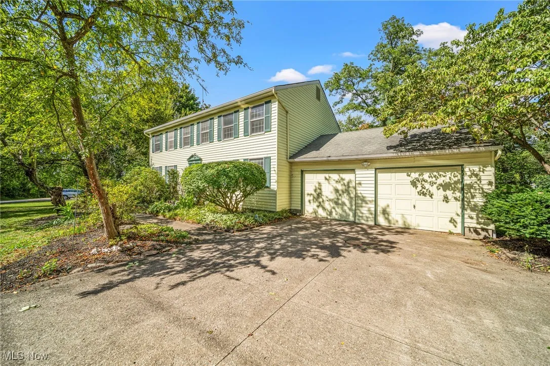 front view with concrete driveway and additional parking pad