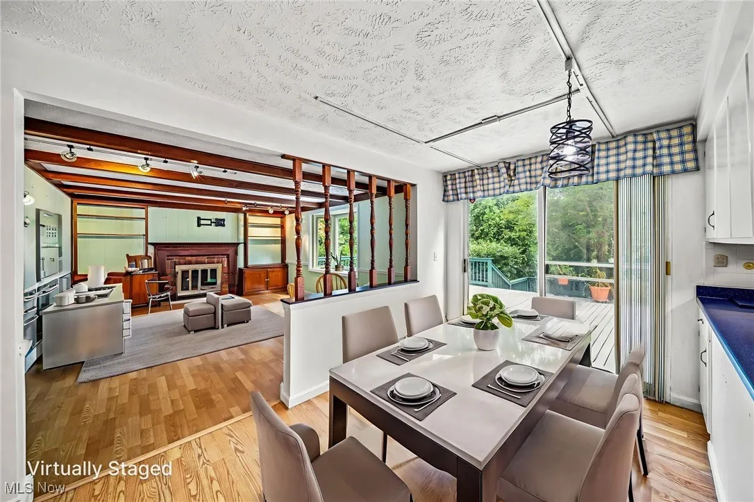 Virtually staged dining area (off of kitchen) with walk out deck access.