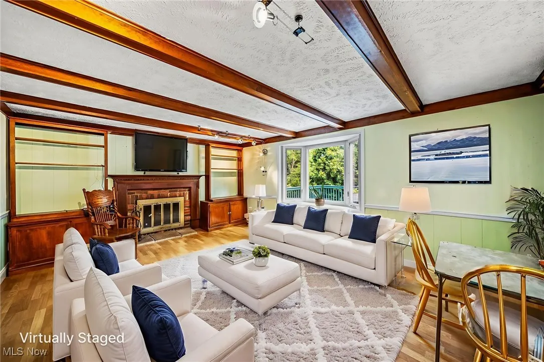 Virtually staged family room with fireplace.