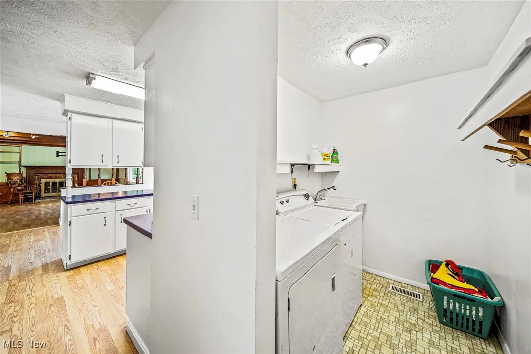 First floor laundry (off of kitchen and direct access from garage).