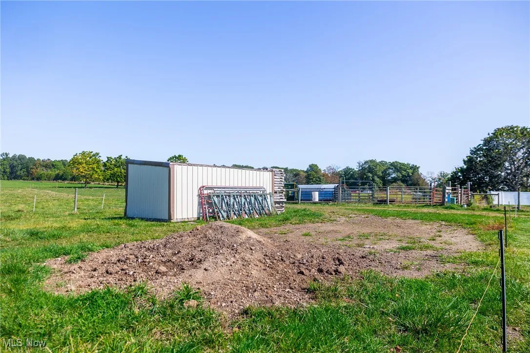 View of yard featuring an outbuilding and a view of countryside