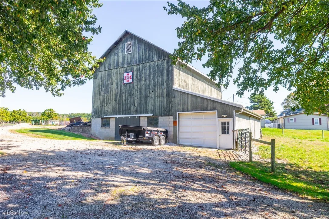 View of barn featuring driveway