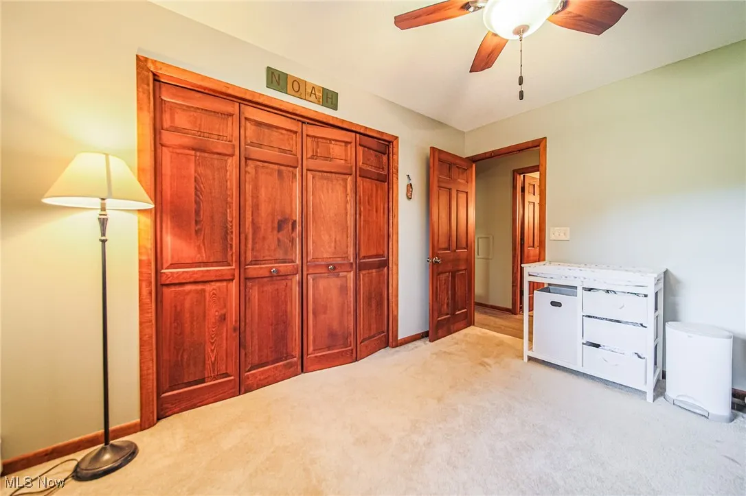 Unfurnished bedroom with light carpet, a ceiling fan, and a​​‌​​​​‌​​‌‌​‌‌​​​‌‌​‌​‌​‌​​​‌​​ closet