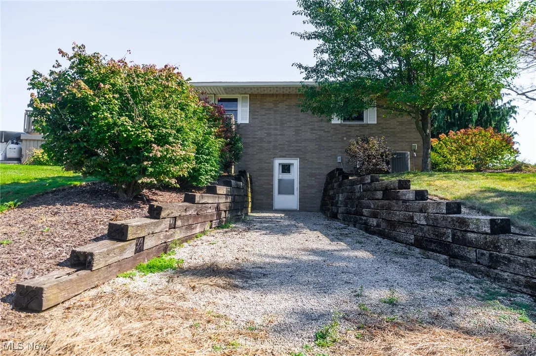 Side view of house with brick siding and a yard