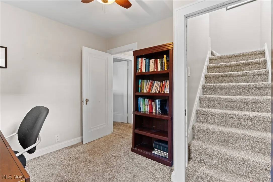 Home office featuring light colored carpet and ceiling fan