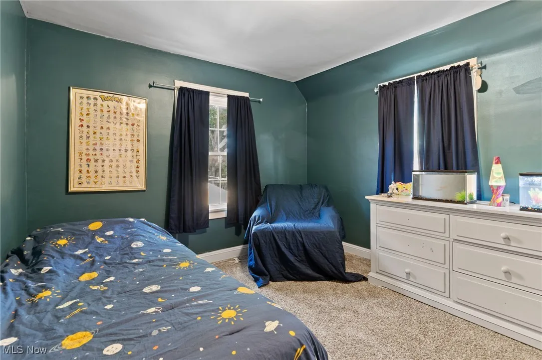 Bedroom with light carpet and baseboards