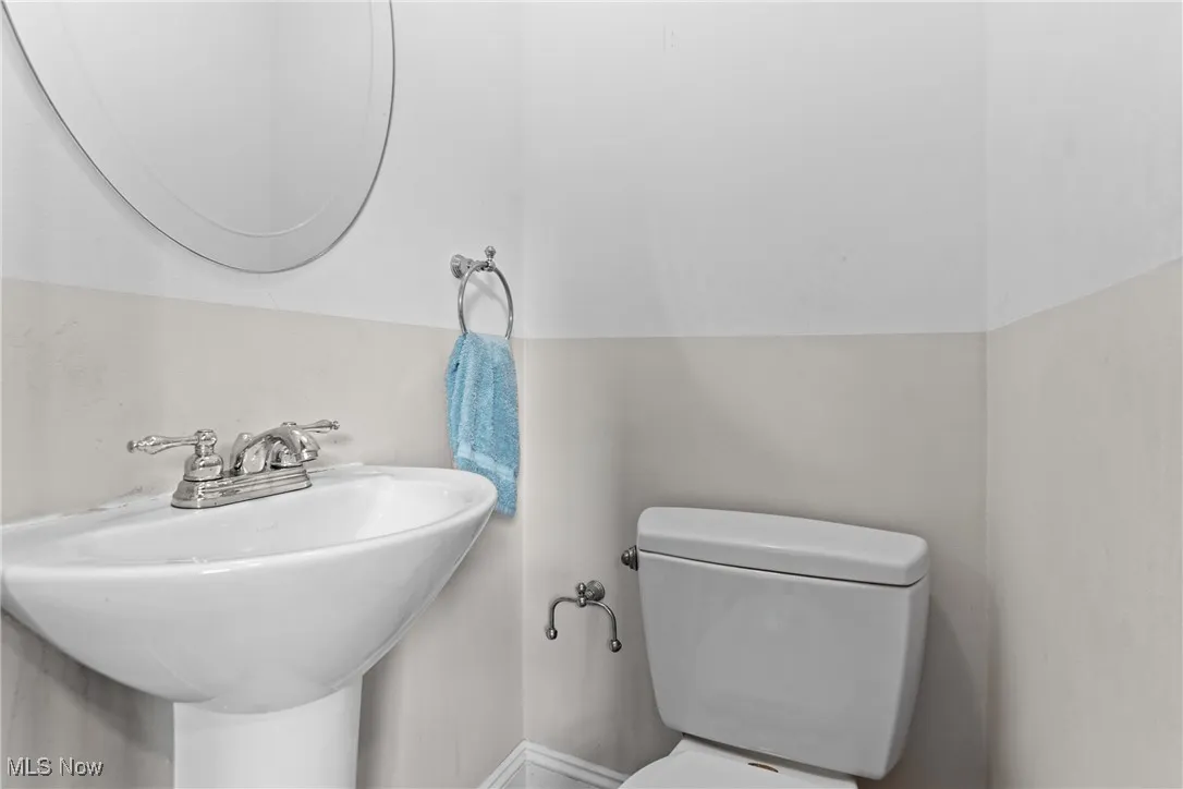 Bathroom with toilet and vaulted ceiling