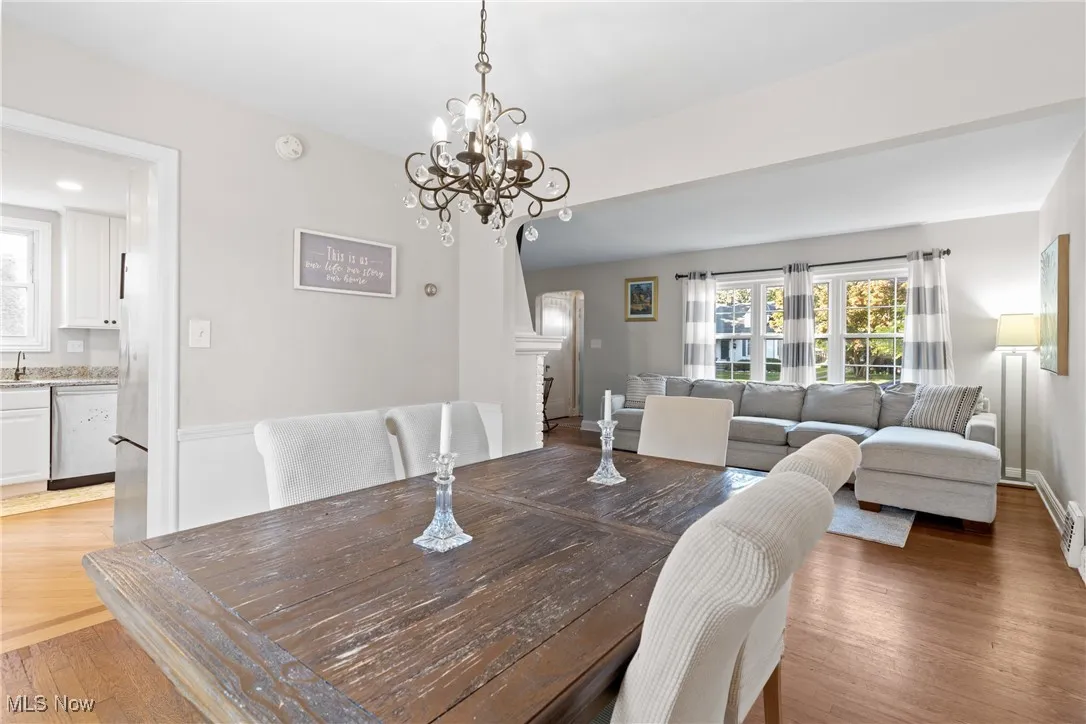 Dining space with light wood-style flooring and a chandelier
